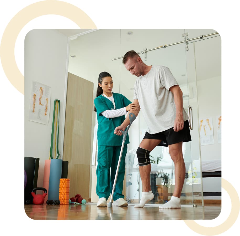 Therapist assisting patient with walking aid.