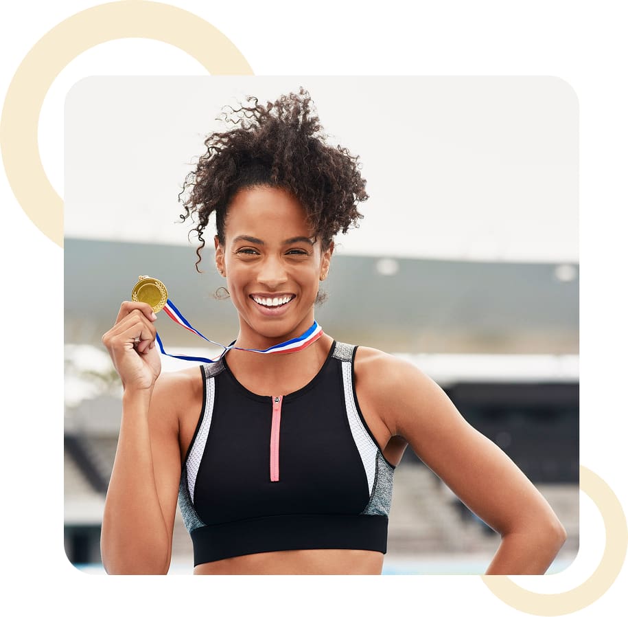 Athlete smiling with a gold medal.