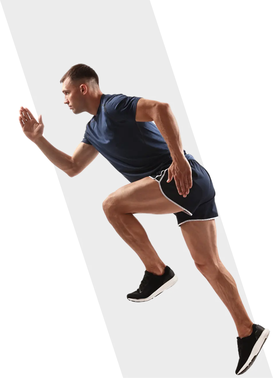 Man sprinting in athletic attire on black.