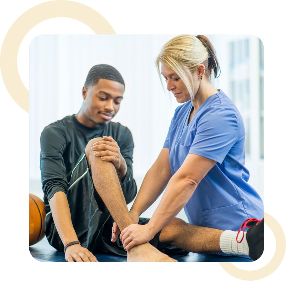 Physical therapist examining patient's leg injury.